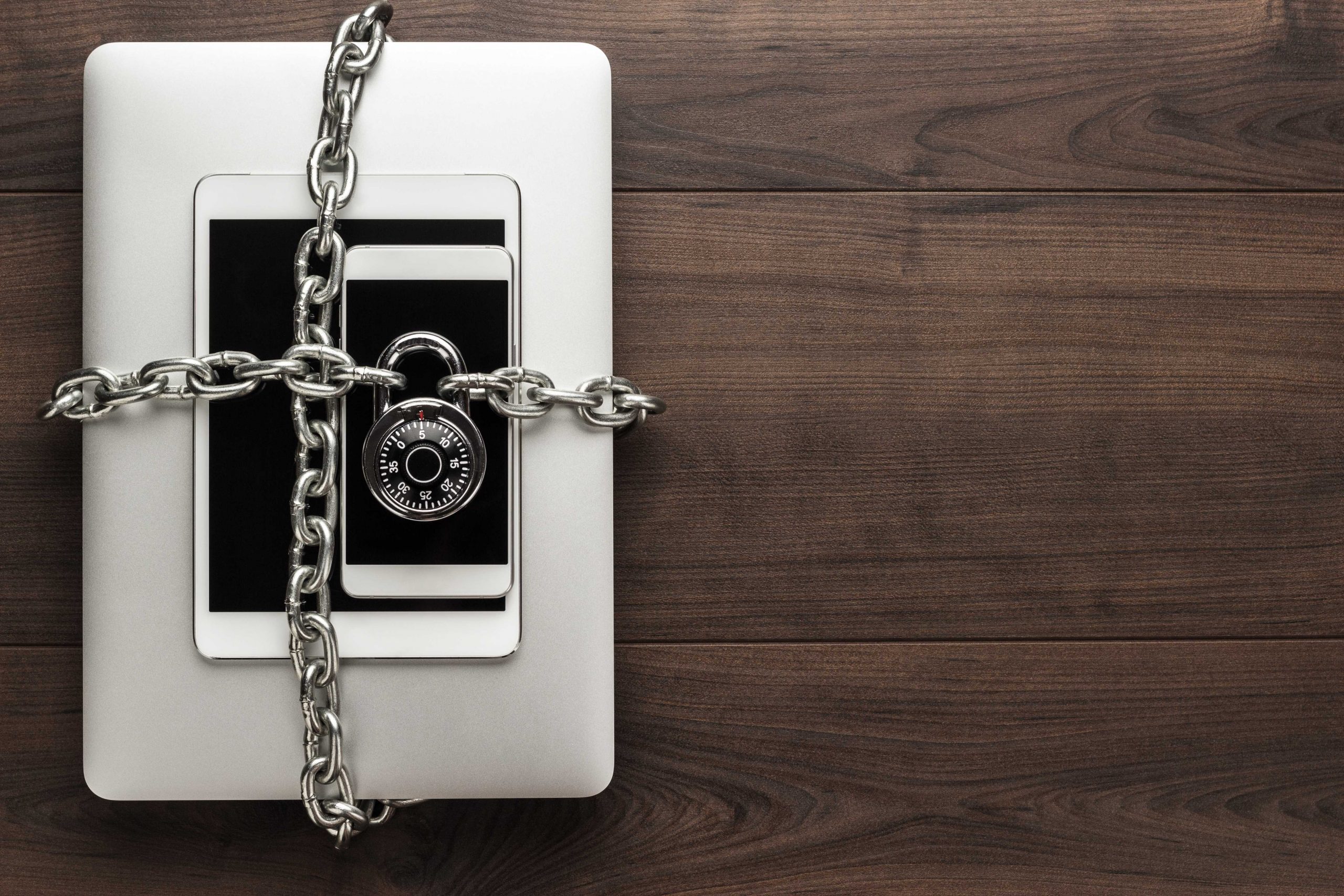 Chained and padlocked laptop and tablet devices | Featured image for Data Security in Business | Blog