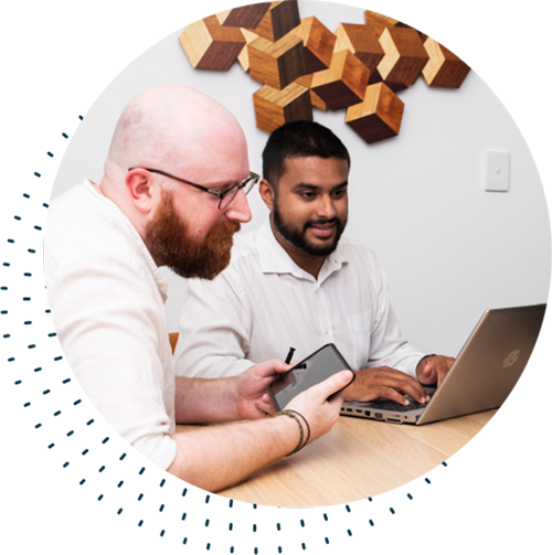 Two men looking at a laptop | Featured image for Business Managed IT Services Page by Connected Platforms.