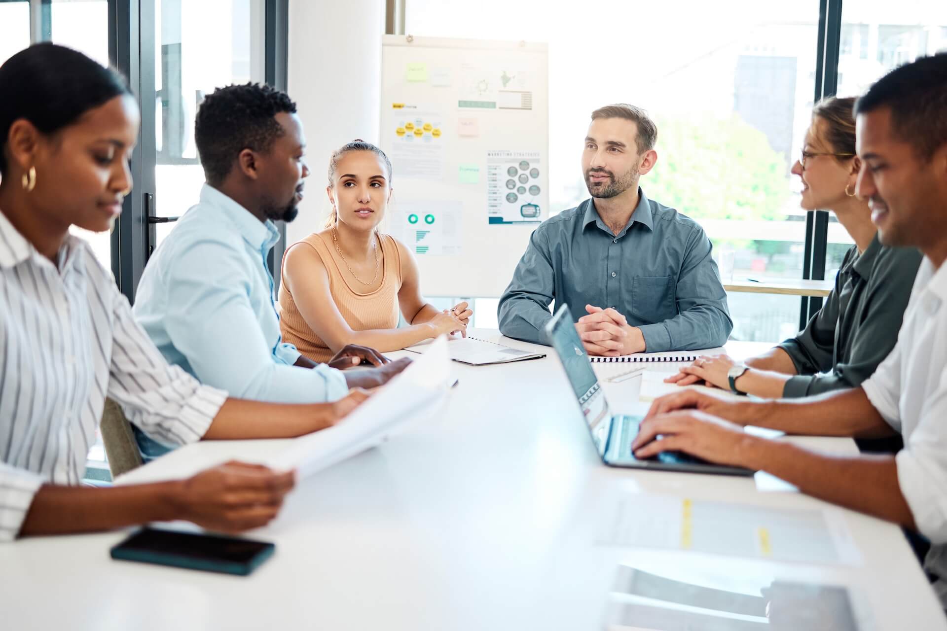 Team of coworkers discussing the importance of a business continuity plan | Featured image for Leadership and the Importance of a Business Continuity Plan Blog on Connected Platforms.