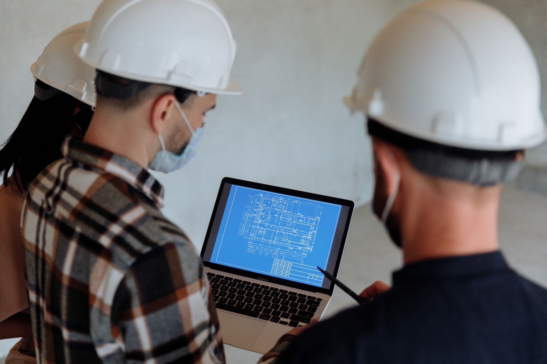 Construction professionals reviewing digital building plans